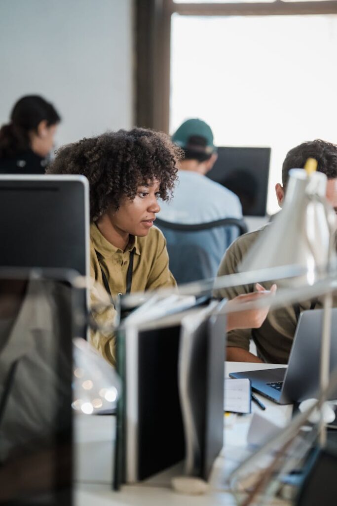 Crafting Captivating Headlines: Your awesome post title goes here Diverse team discussing work at shared desk in open office space.