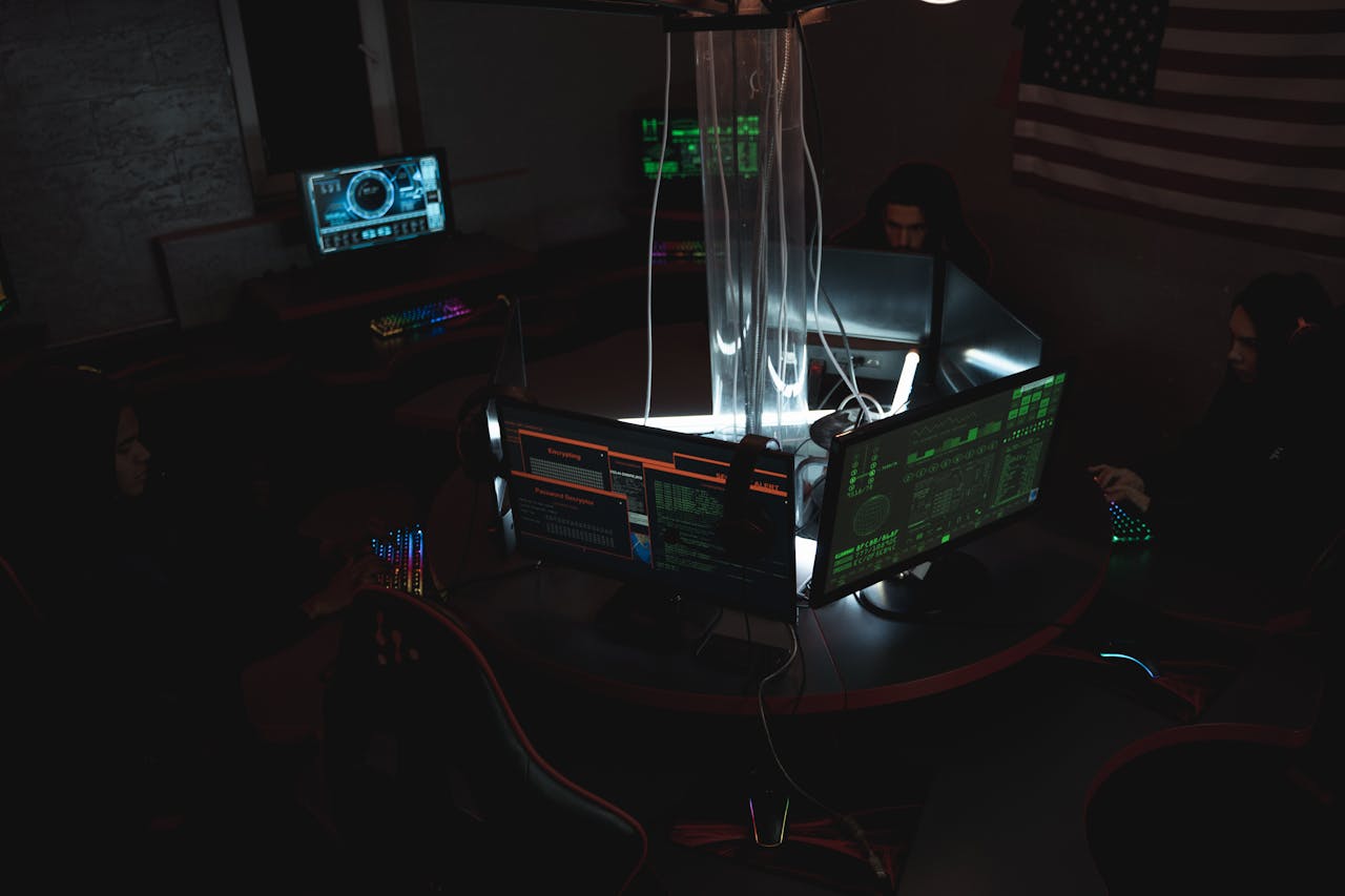 Offerings Team of cybersecurity experts collaboratively working on data protection in a dimly lit room filled with computers.